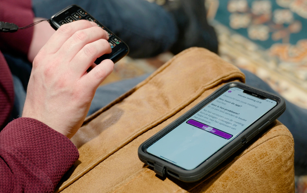 A blind user is testing an app using VoiceOver and a small Bluetooth keyboard